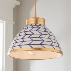 a white and blue lamp hanging from a ceiling