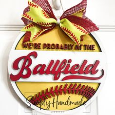 we're probably at the ballfield sign with baseballs on it and red bows