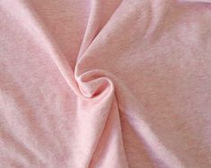 a close up view of a pink shirting material that looks like it has been dyed