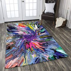 a colorful area rug is on the floor in front of a white door and chair