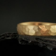 22K Gold Men's Wedding Ring 5mm Wide Gold Hammered Band Brushed Matte Hammered Ring Rustic Men's Wedding Band Solid 22K Gold Ring This solid 22K gold ring begins as 5mm wide by 1.5mm thick half round gold stock. We hand forge your ring to size just for you and give it a hand hammered surface. It is then brushed matte for a unique look. Your ring can also be hammered and high polished if you prefer. This ring in 14K gold (one of our BEST SELLERS): https://www.etsy.com/listing/208112020 This ring in Silver (also one of our BEST SELLERS): https://www.etsy.com/listing/207194258 Blazer Arts is a family-owned and operated small but growing business that first opened up shop on Etsy in 2008. We now have multiple Etsy shops. Please see our about page for details. At the center of it all is Deb who Hammered 22k Gold Wedding Jewelry, Gold Hammered Round Band For Wedding, Hammered Gold Rings For Wedding, Gold Hammered Wedding Bands, Gold Hammered Wedding Rings, Hammered Gold Wedding Band, 22k Gold Ring, Growing Business, Gold Stock