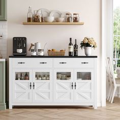 a kitchen with white cabinets and green cupboards