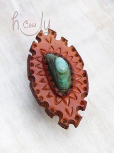 This unique one off leather ring is 100% handmade from the finest quality leather. It is beautifully designed with an amazing turquoise gemstone. The ring is adjustable at the base so it fits most finger sizes. It is perfect for every occasion especially parties and festivals. Approximate Dimensions: Length 8 cm Width 4.5 cm Unique Turquoise Ring With Concho For Gift, Gift Turquoise Ring With Concho, Adjustable Artisan Turquoise Ring With Concho, Turquoise Leather Concho Jewelry, Leather Concho Jewelry, Hippie Ring, Ring Leather, Hippie Rings, Ring Turquoise