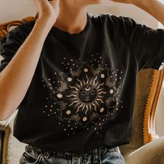 Get ready to OBSESS over your new favorite spiritual tee. With a minimal but powerful design, this shirt is the perfect way to emit all those celestial, astrological and witchy vibes! This is the perfect trendy Mystical Sun shirt! Great as a gift for anyone that loves diving into astrology, witchy things or your spiritual bestie! * Q U I C K * F A C T S * ✺ These t-shirts have-ribbed knit collars to bolster shaping. The shoulders have taping for better fit over time. Dual side seams hold the garment's shape for longer. .: 100% Airlume combed and ringspun cotton (fiber content may vary for different colors) .: Light fabric (4.2 oz/yd² (142 g/m .: Retail fit .: Tear away label .: Runs true to size ✺ Care instrutions: Non-chlorine: bleach as needed; Tumble dry: low heat; Iron, steam or dry: m Sun T Shirt, Dark Academia Shirt, Witchy Clothes, Astrology Shirt, Sunshine Shirt, Peter Pan Collars, Oversized T Shirt Dress, Witchy Fashion, Sun Moon Stars