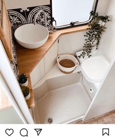 a small bathroom with a sink and toilet in it's corner area next to a window