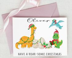 a christmas card with an image of two dinosaurs on the front and one dinosaur on the back that says clever have a roar - some christmas