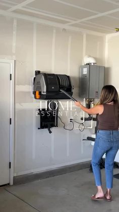 a woman is standing in front of a machine