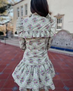 Saddle up in style with the Quinlynn Taupe Floral Ruffle Bow Dress. This versatile dress is perfect for any occasion, whether you're hitting the rodeo in your cowgirl boots or stepping out in the spring sun with wedges. With its playful ruffle and bow details, you'll be the talk of the town. Giddy up and grab yours today! Product Details: Features: Adjustable bow tie. Ruffle details. Side zipper closure. Fit: True to size. Model is 5'3 and wearing a size small. Fabric: 100% cotton; Lining- 100% Long Sleeve Ruffle Dress With Ruffle Hem For Spring, Knee-length Mini Dress For Garden Party In Fall, Fitted Dresses With Ruffle Hem For Day Out, Fall Garden Party Knee-length Mini Dress, Fall Ruffled Mini Dress For Garden Party, Spring Daywear Dress With Ruffle Hem, Spring Casual Dress With Ruffled Collar, Knee-length Ruffle Dress For Spring Garden Party, Casual Spring Dress With Ruffled Collar