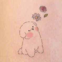 a small dog with a flower on its back side ribcage, sitting next to it's belly