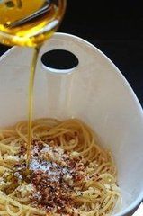 a white bowl filled with pasta and olive oil