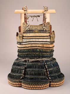 an old woven purse is sitting on a table with two handles and straps hanging from it