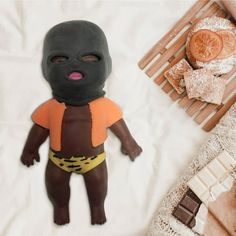 a small doll with a black mask on it's face