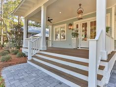 a porch with steps leading up to the front door