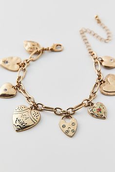 Vintage-inspired charm bracelet trimmed with a mix of heart-shaped charms. Choose from a silver or gold bracelet. Features Kyla heart charm bracelet Vintage-style charm bracelet Adjustable length Content + Care Mixed metal, glass Avoid contact with water Imported Size Dimensions: 7.5" l + extender | Kyla Heart Charm Bracelet in Gold, Women's at Urban Outfitters Heart-shaped Charm Bracelet With Dangling Charms For Valentine's Day, Gold Metal Charm Bracelet With Heart Beads, Urban Outfitters Gold Jewelry For Gift, Urban Outfitters Gold Jewelry For Gifts, Heart-shaped Bracelets With Dangling Charms, Metal Bracelet With Heart Charm, Metal Heart Bracelet With Charms, Valentine's Day Metal Charm Bracelet With Heart Beads, Metal Heart-shaped Charm Bracelet With Heart Beads