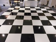 a black and white checkerboard floor in a hotel lobby with tables set up for an event