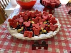 a plate with cut out hearts on top of it sitting on a red and white checkered table cloth