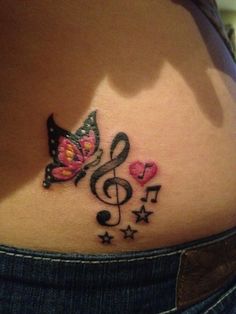 a woman's stomach with music notes and a butterfly tattoo on her lower back