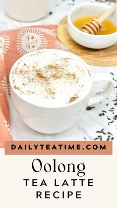 there is a cup of coffee with cinnamon on top and the words oolong tea latte recipe below it