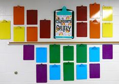 colorful bulletin board with clipboard gallery attached to the wall in a school classroom setting