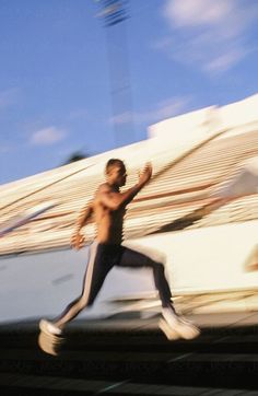 a man running on train tracks in motion