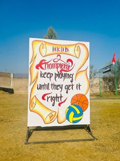 a sign that is in the grass with a basketball ball and some writing on it