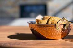 a bowl filled with food sitting on top of a wooden table