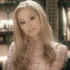 a woman with long blonde hair sitting down