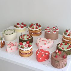 a table topped with lots of different types of cakes