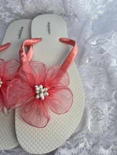 These beautiful white flip flop is hand wrapped in coral satin ribbon, and adorned with a matching organza flower with pistils in the center. Ribbon color is coral if you are needing other colors of ribbon or decoration please contact me and will be happy to accommodate you! All flip flops are handmade to order and the production time is 5-7 business days and then please allow additional time for shipping. Amazing for beach, weddings, flower girl or a fancy event, you choose! Please choose your White Sandals For Spring Gift, White Sandals As Spring Gift, White Summer Flip Flops For Party, White Summer Party Flip Flops, White Summer Flip Flops As Gift, Pink Party Flip Flops For Summer, Pink Summer Party Flip Flops, White Flip Flops As Summer Gift, Adjustable Flip Flops For Summer Party