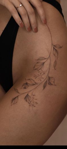 a close up of a person's thigh with flowers on it and a ring in the middle