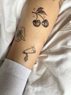 a woman's arm with tattoos on it and an arrow in the middle of her arm