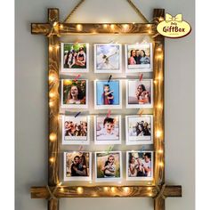 a wooden frame with pictures hanging from it's sides and lights around the edges