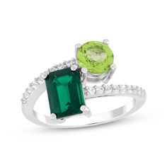 Make them green with envy when you slip on this marvelous two-stone ring. Sterling silver A glamorous emerald-cut lab-created emerald and a round-cut peridot make a pretty pair White lab-created sapphires glimmer on the bypass-style band Green Emerald Cut Birthstone Ring With Accent Stones, Modern Green Jewelry With Accent Stones, Emerald Cut Green Gemstone Jewelry, Green Three Stone Emerald Cut Jewelry, Green Emerald-cut Gemstone Accent Jewelry, Green Emerald Cut Jewelry With Gemstone Accents, Modern Emerald-cut Green Diamond Ring, Green Diamond Multi-stone Birthstone Ring, Green Diamond Birthstone Ring With Multi-stone