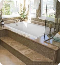 a bath tub sitting next to a window in a bathroom