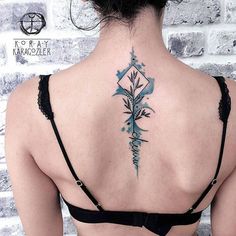 the back of a woman's neck is covered with blue watercolors and flowers