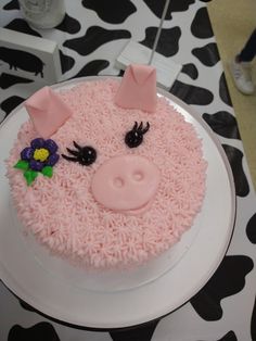 a cake decorated with pink frosting and pig ears