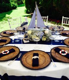 the table is set with plates and place settings for an outdoor dinner or party event