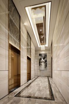 an empty hallway with marble floors and walls