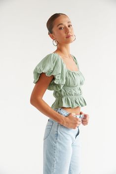 This Item is excluded from promotions. The Dottie Puff Sleeve Ruffle Crop Top is the perfect everyday top with dramatic puff sleeves that can be worn on or off the shoulders, and a tiered, cinched bodice. Featuring a square neckline and a ruffle hem. Pair with the Rolla's Heidi Jean to complete this flirty casual look. Details 80% Viscose, 20% Nylon Cropped Elastic armholes Stretchy fit Hand wash cold / Line dry Balloon Sleeve Tops With Ruffles For Day Out, Green Puff Sleeve Smocked Top, Puff Sleeve Ruffled Crop Top For Brunch, Puff Sleeve Ruffle Crop Top For Day Out, Puff Sleeve Crop Top With Ruffles For Day Out, Trendy Cropped Puff Sleeve Top With Ruffles, Green Puff Sleeve Top With Ruffles, Green Puff Sleeve Tops With Ruffles, Casual Peplum Top With Smocked Bodice And Puff Sleeves