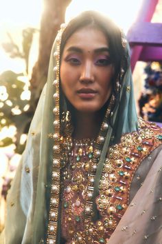 Editor's Note Featuring a brick brown scalloped peplum kurta embroidered with gold metal embellishments, precious stones, and pearls, appliquéd with silk.It is paired with flared sharara pants appliquéd with teal, pink & ivory fabrics. This bridal look is complete with an ivory scalloped dupatta and teal tissue organza head dupatta. Color: Multicolor Fabric: Silk, tissue organza Sleeve type: Full Embroidery details: Gold metal embellishments, precious stones, and pearls Component: Sharara, kurta Luxury Silk Sharara With Intricate Embroidery, Luxury Multicolor Sharara For Wedding, Luxury Multicolor Sharara For Party, Luxury Brocade Sharara With Intricate Embroidery, Luxury Brocade Sharara With Cutdana, Luxury Sharara With Multicolor Embroidery For Transition Season, Luxury Embellished Designer Sharara, Luxury Embroidered Brocade Sharara, Luxury Gold Sharara With Pallu