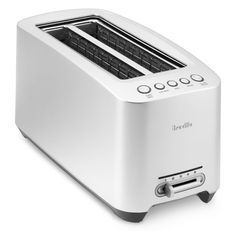 a white toaster sitting on top of a table