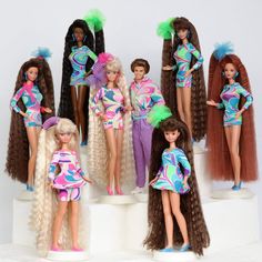 many dolls are posed in different outfits and hair styles, including long - haired wigs