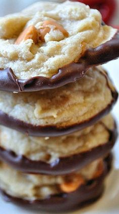 a stack of cookies with chocolate and nuts on top