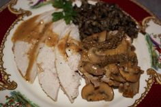 a white plate topped with meat covered in mushroom gravy