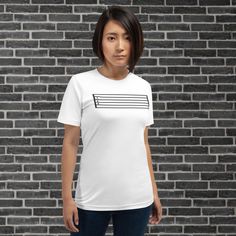 Professional Guitarists and guitar students alike know what this is. this blank guitar tablature shirt comes in many colors and fits just about every guitarist. Simple gray Guitarist Blank Tablature T-shirt * 100% combed and ring-spun cotton (Heather colors contain polyester) * Fabric weight: 4.2 oz./yd.² (142 g/m²) * Pre-shrunk fabric * Side-seamed construction * Shoulder-to-shoulder taping * Blank product sourced from Nicaragua, Mexico, Honduras, or the US This product is made especially for y White Band Merch Shirt With Logo, White Pre-shrunk Shirt For Concert, Music-themed White Short Sleeve Shirt, White Music-themed Top For Concerts, Unisex White T-shirt For Concert, White Unisex T-shirt For Concerts, White Music-themed T-shirt With Band Logo, White Music-themed T-shirt For Fans, White Music-themed Fan Merchandise T-shirt