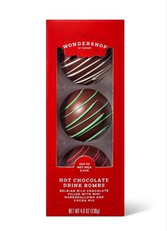 three chocolate truffles in a red box with green stripes on the inside