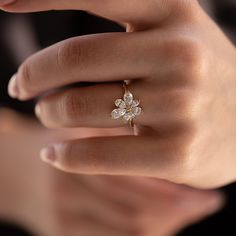 a woman's hand with a diamond ring on it