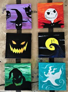 halloween paintings are hung on the wall in front of a building with pumpkins and jack - o'- lantern faces