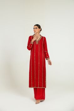 Adorn Yourself In This Crimson Red Pure Jamawar Long Shirt All Handworked With Dabka, Resham, Nakshi, Zardozi And Mirrorwork Details (Fully Worked Front And Back) Paired With Matching Wide-legged Pants With Matching Work On The Bottom. (Includes Shirt And Pants) Designer Red Dabka Palazzo Set, Red Palazzo Set With Resham Embroidery For Celebration, Traditional Red Palazzo Set For Celebration, Red Embroidered Palazzo Set For Celebration, Embroidered Red Palazzo Set For Celebration, Elegant Red Raw Silk Palazzo Set, Elegant Red Palazzo Set For Festive Occasions, Festive Red Palazzo Set With Dabka, Festive Red Dabka Palazzo Set