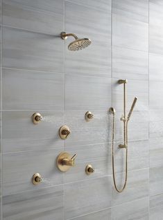 the shower head and handset are connected to the wall in this modern style bathroom